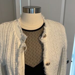 Winter white, luxurious knit sweater with gold button details.